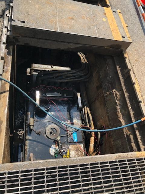 Network-transformer vault interior with high-voltage cabling, viewed through the access opening